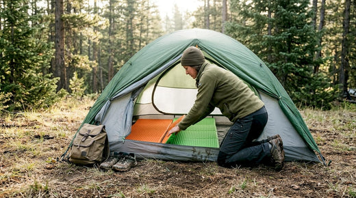 Camper assembling modular pad at tent entrance