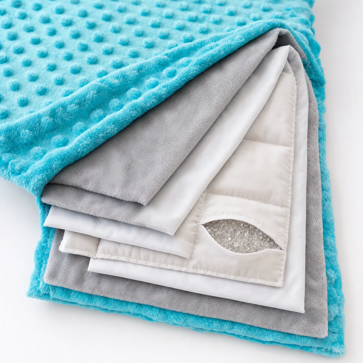 Cutaway of the Hazli weighted blanket showing the minky cover, microfiber layers and glass-bead pockets